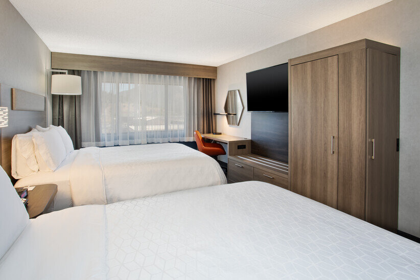 a room with two beds and a tv