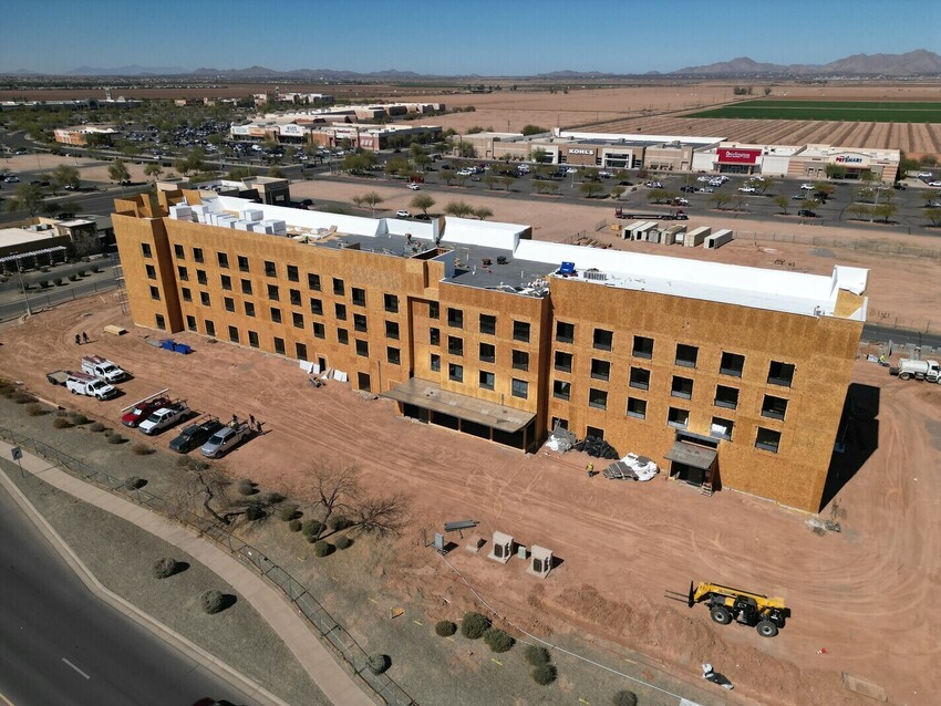 a building with many windows and a road in the background